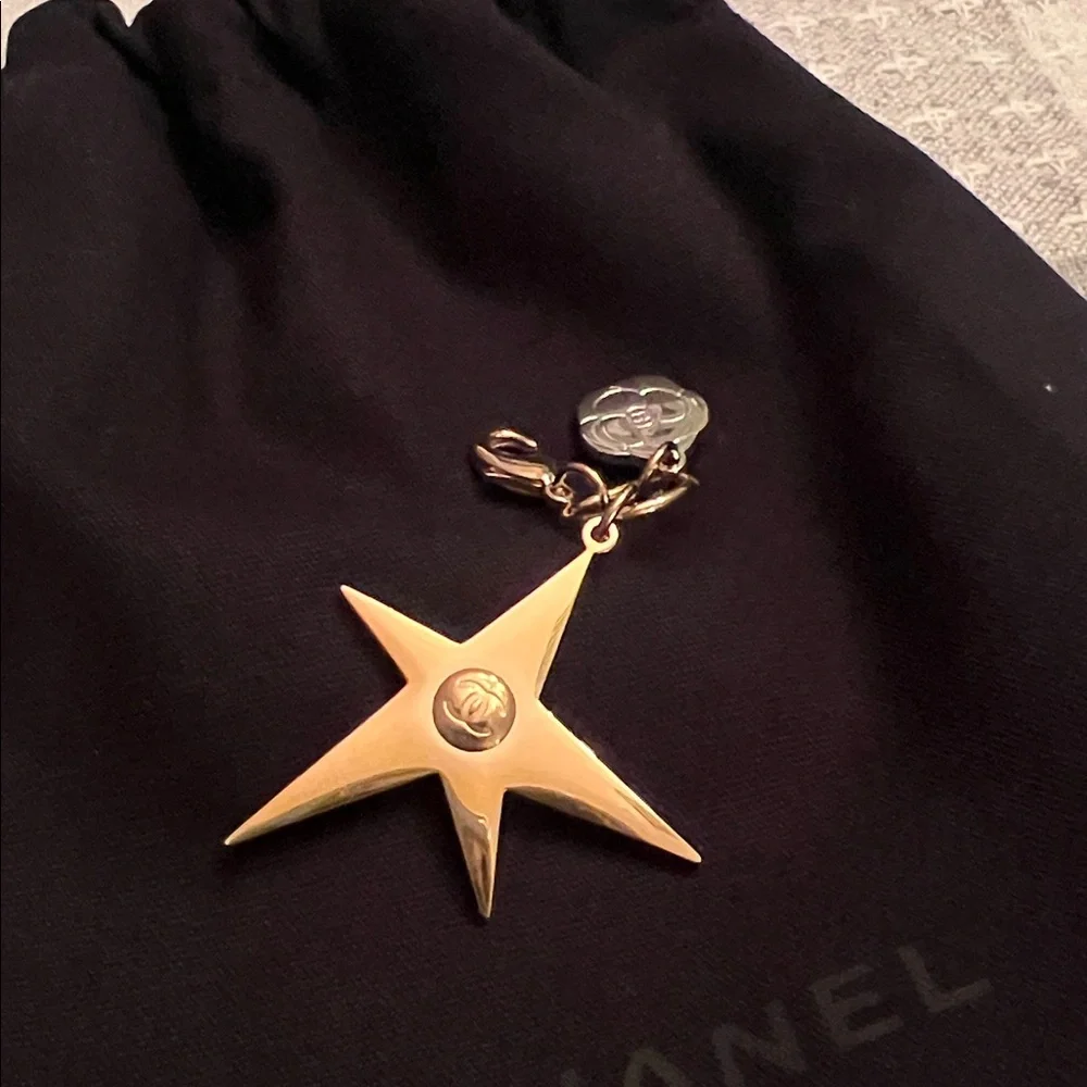 CHANEL Gold Star & small Camellia key Charm with black drawstring pouch.